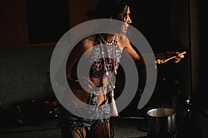 Woman coocking in darkness photo