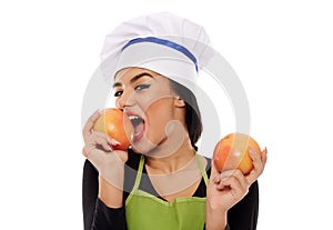 Woman cook biting grapefruit