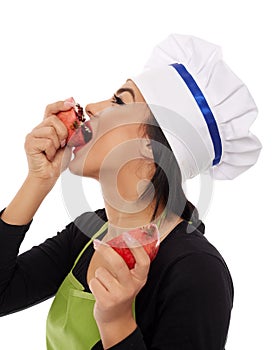Woman cook biting pomegranate fruit