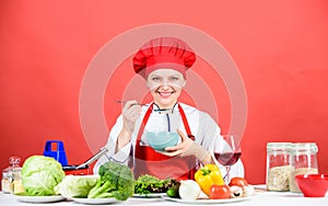Woman in cook hat. professional chef on red background. happy woman cooking healthy food by recipe. organic eating and