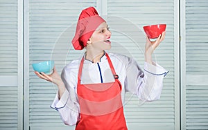 Woman cook hold bowls. How many portions would you like to eat. Calculate amount calorie you consuming. Calculate normal