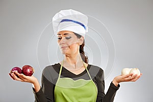 Woman cook holding red and white onions