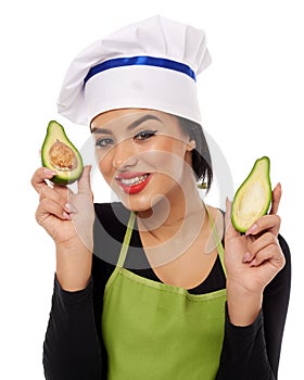 Woman cook holding sliced avocado