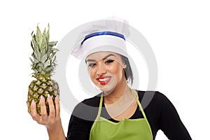 Woman cook offering pineapple