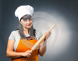 Woman cook with rolling pin