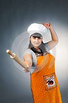 Woman cook with rolling pin