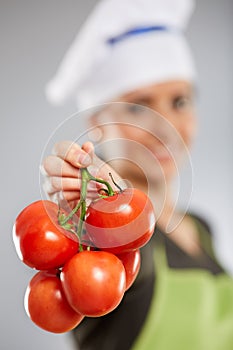 Woman cook with tomatoes