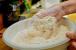 Woman cooking brazilian cheese bread chipa in bowl
