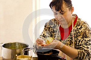 Woman cooking cabbage roll (sarmale)