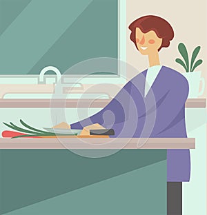 Woman cooking and cutting vegetables with knife in kitchen