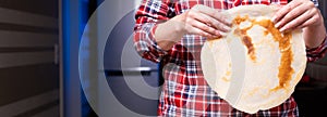 Woman cooking delicious crepe on electric pancake maker in kitchen, closeup