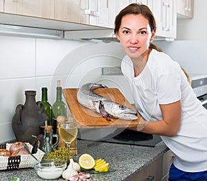 Woman cooking fish for dinner