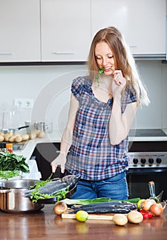 Woman cooking fish in fryingpan