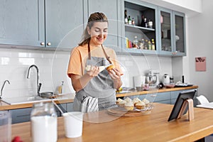 woman cooking food and baking on kitchen at home