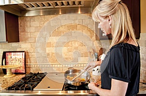 Woman cooking on a gas range
