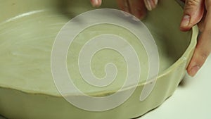 Woman cooking and greasing baking tray