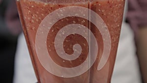 Woman cooking at home, fruit berry cocktail with sesame, close-up of blends ingredients in a mixer. healthy breakfast.