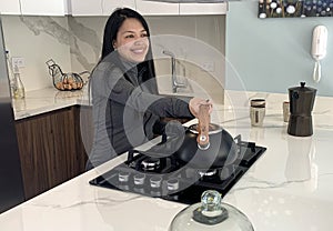 Woman cooking in kitchen making healthy food
