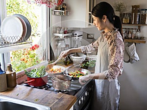 Woman cooking lunch in a kitchen