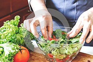 Woman cooking mixing salad