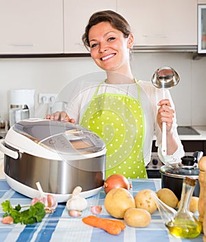 Woman cooking with multicooker