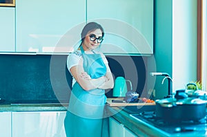 Woman cooking in new kitchen making healthy food with vegetables