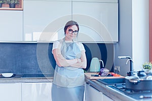 Woman cooking in new kitchen making healthy food with vegetables