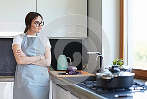 Woman cooking in new kitchen making healthy food with vegetables