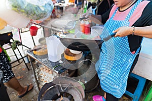 Woman Cooking Noodle Soup Outdoors On Traditional Street Market In Asia Food Preparing On Open Bazaar