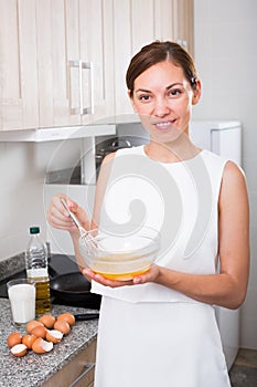 Woman cooking omelet