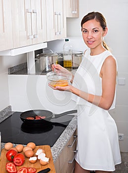 Woman cooking omelet