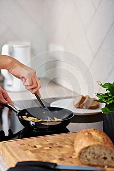 Woman cooking omelet , use induction stove and frying pan