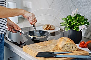 Woman cooking omelet , use induction stove and frying pan