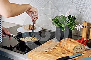 Woman cooking omelet , use induction stove and frying pan