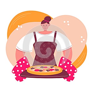 Woman cooking pizza at home. Young woman and freshly baked pizza with salami sausages.