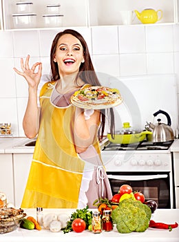 Woman cooking pizza.