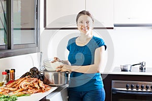 Woman cooking rice with seafoods photo