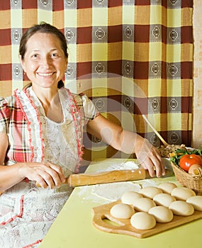 Woman cooking with rolling pin