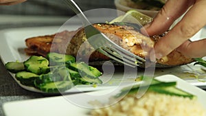 Woman cooking salmon fish at home