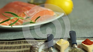 Woman cooking salmon fish at home set