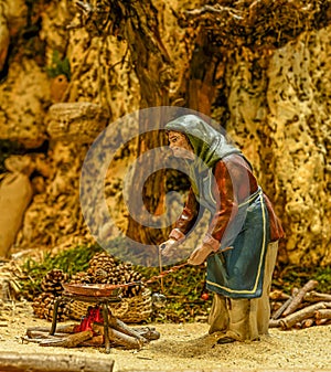 Woman cooking in a street, from the portal of Belen.