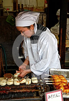 Woman cooking sweet Mitarashi Dango