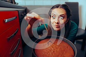 Woman Cooking Using a Toothpick Checking on her Baked Cake.