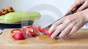 Woman is cooking. Women`s hands cut vegetables on a cutting board