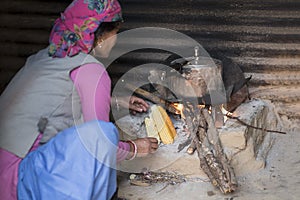 Woman cooking on wood fire