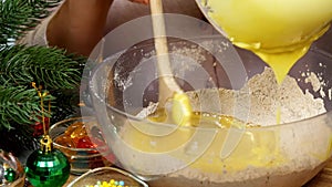 Woman cooks dough for Christmas cookies and decorations Xmas tree