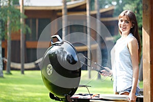 Woman cooks on grill