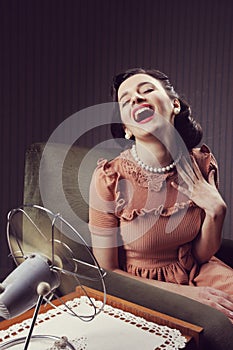 Woman cooling herself with fan