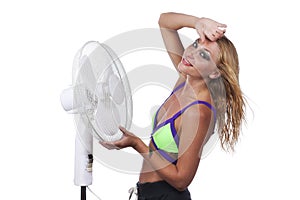 Woman cools down with fan