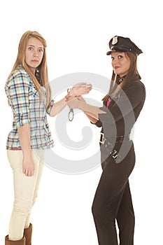 Woman cop handcuff woman looking